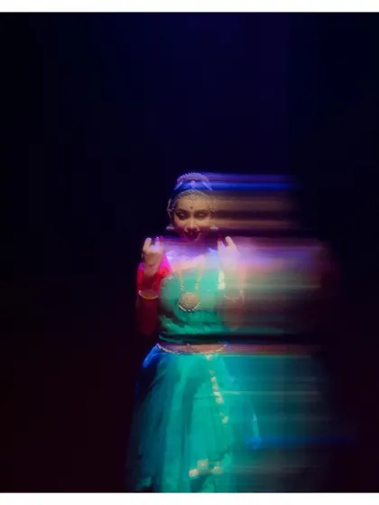 An artistic shot using motion blur to capture the swift movement of a dancer in "Tyāgarāja Hṛt Sādana." It conveys the energy and speed of the choreography.