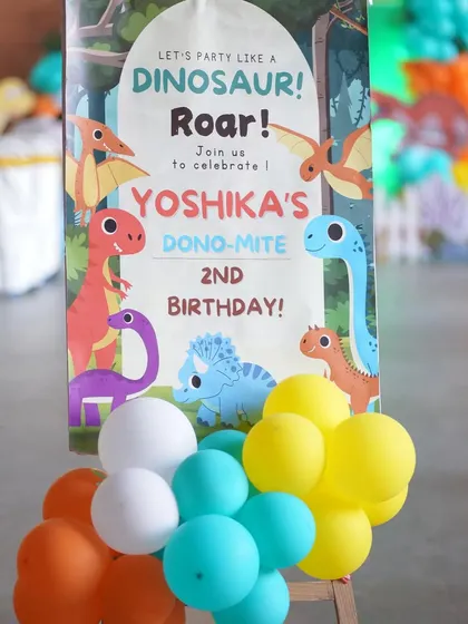 A close-up of the 'Dino-Mite' 2nd birthday welcome sign.