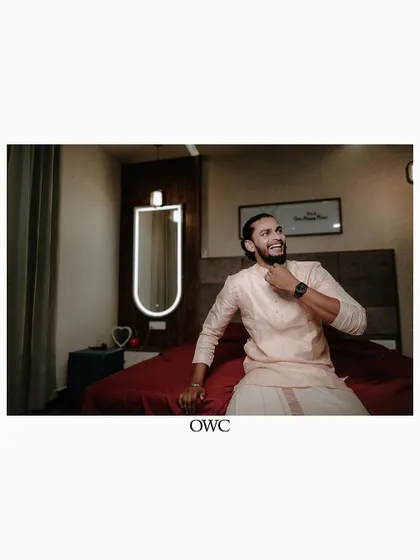 A candid shot of the groom getting ready, full of anticipation and happiness.