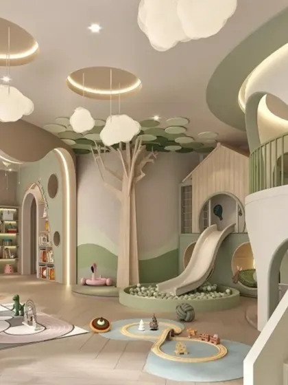 An alternate view of the playzone, showcasing the cloud-like light fixtures and the tree-inspired architectural elements that bring the outdoors inside.