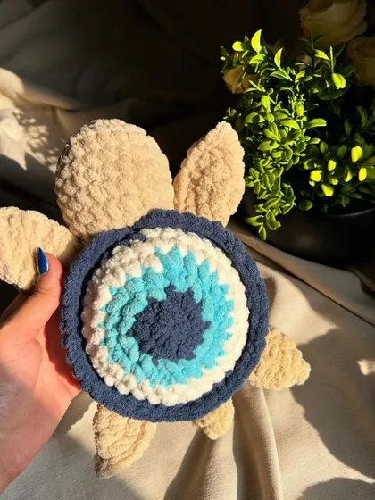 An evil eye-themed crochet turtle for good vibes and protection. This unique design combines the popular symbol with our beloved turtle shape, making it a meaningful and decorative piece.