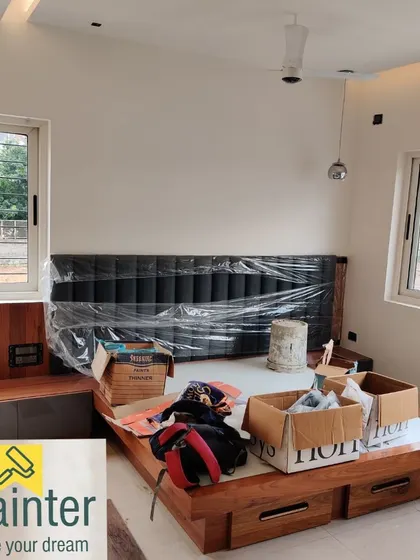 Here you can see our work in progress on a bedroom set. We carefully mask and protect all surrounding surfaces, including the new headboard, to ensure a clean and precise job.
