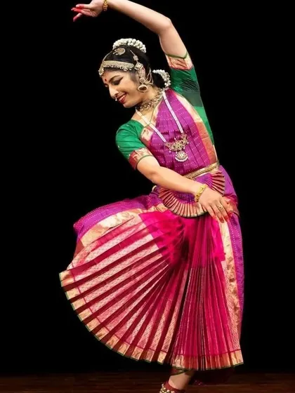 A student in a dynamic pose, her vibrant costume a testament to Manjunath's skill.