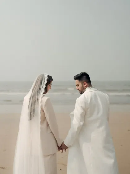 A quiet moment of reflection by the sea. This portrait captures the couple holding hands, looking out at the horizon, a beautiful metaphor for the journey they are beginning together.