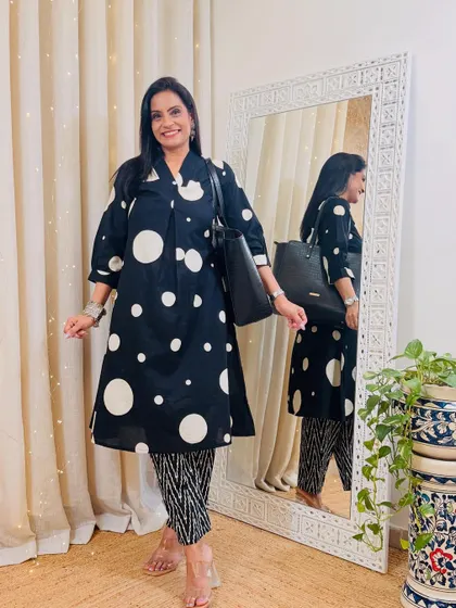 A playful black and white polka dot kurta paired with contrasting printed pants. This is a fun mix-and-match look that shows personality.