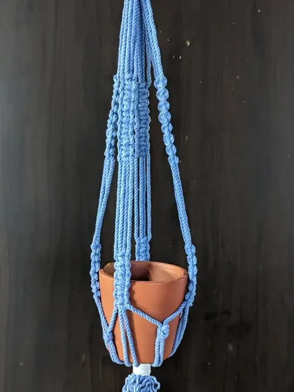 A beautiful blue macrame plant hanger, created in one of our fiber art workshops. Learn the basic knots and create your own boho-chic home decor.