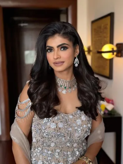 This angle highlights the beautiful side braid and the volume in her hair. It's a great hairstyle that keeps the hair off the face while still looking soft and romantic.