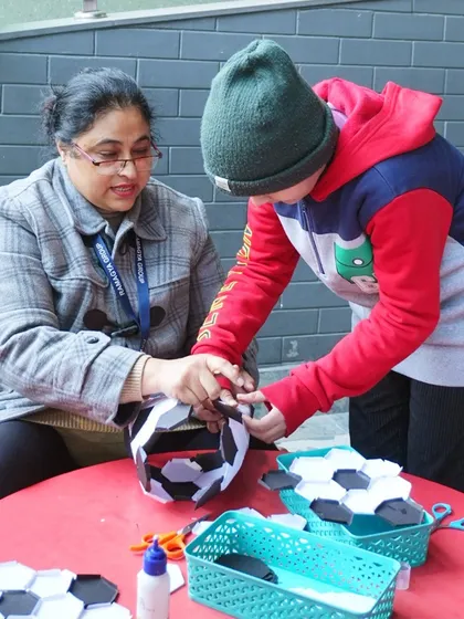 A creative break from the football action. This craft activity allowed kids to make their own paper footballs, adding a hands-on element to the themed party.
