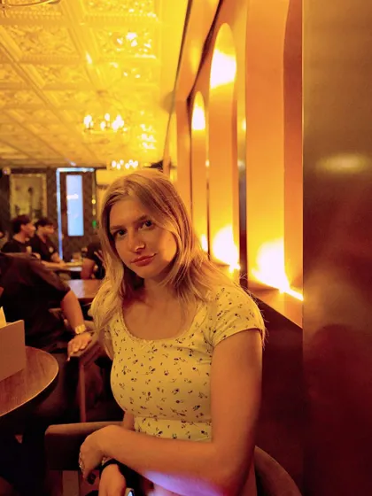 Another guest enjoying the unique, golden-hued lighting of the venue.