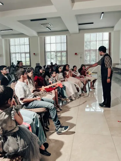 Engaging with the front row during a performance in a large, well-lit hall. I make sure to connect with audience members throughout the show.