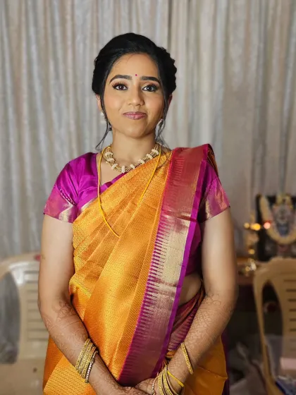 A classic South Indian look for Varsha's Varapooje, with a bright silk saree and traditional jewelry.