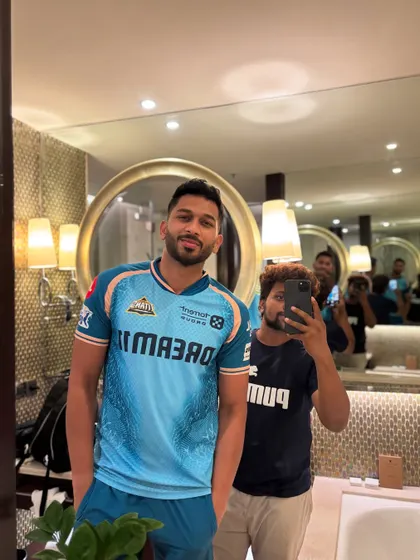 With the powerful Shahrukh Khan of the Gujarat Titans. A clean fade and sharp lineup are essential.