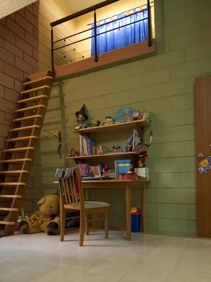 In this child's room at the Sharada Residence, we used stabilized mud blocks for the walls, paired with a wooden ladder leading to a loft. This choice of material is both sustainable and adds a playful, tactile quality to the space.