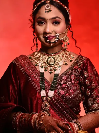This stunning bride in her red lehenga is a perfect example of a classic North Indian bridal look. We focused on radiant skin, bold eyes, and a traditional bridal bun adorned with flowers.