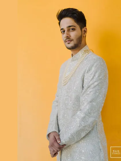 A duplicate of 302, another take on the groom's dapper portrait against the yellow backdrop.