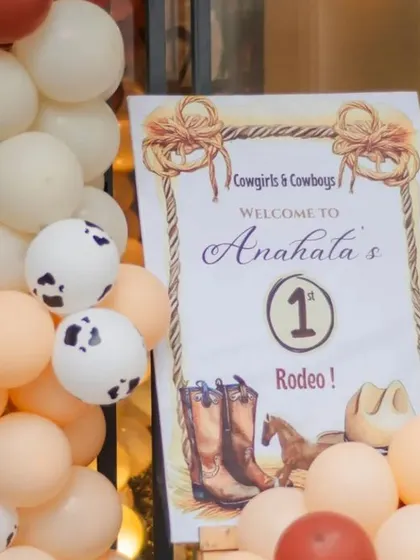 A close-up of the welcome sign for the 'Cowgirls & Cowboys' rodeo party.