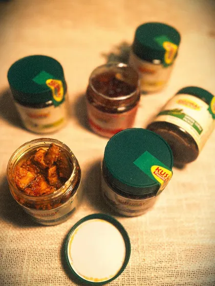 A candid shot of my pickle family. This image shows a variety of my pickles, both open and sealed, giving you a real sense of my product range.