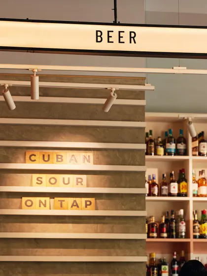 Our beer taps and a sign for our cocktail of the day, the Cuban Sour. We offer a range of craft beers and creative drinks on tap.