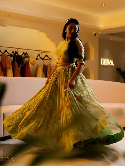 A dreamy, ethereal lehenga for the modern woman. This piece features a flowing, pleated skirt with a soft floral print, paired with a matching full-sleeve blouse for a look of effortless elegance.