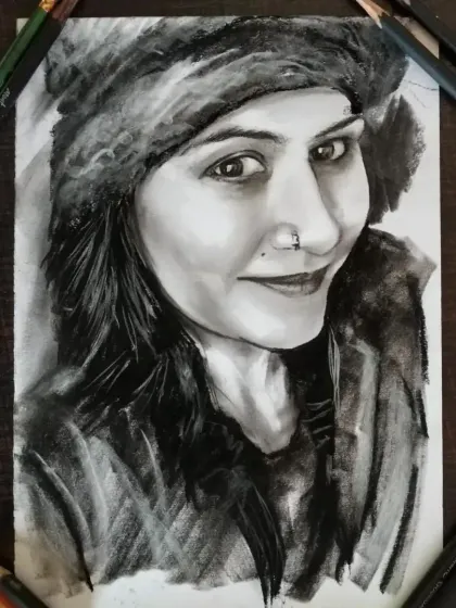 A charcoal sketch of a client wearing a winter hat. The texture of the fur and the soft shading on her face are key details.