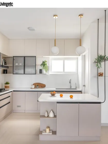 The bright and airy kitchen from my Livingetc-featured home. The design balances white cabinetry with a functional island and decorative shelving, proving that practical spaces can also be beautiful.