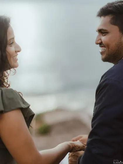 A close-up capturing the genuine smiles and easy conversation between the couple during their Goa pre-wedding shoot.