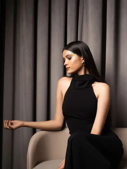 A seated portrait from a high-fashion shoot. The elegant pose and sophisticated styling in this shot are perfect for showcasing a model's suitability for luxury brand campaigns.
