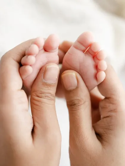 A macro shot capturing the tiny, perfect details of a newborn's feet. These detail shots are a beautiful way to remember just how small they once were.