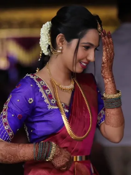 A candid, happy moment. The bride's genuine smile is the best accessory, and her makeup is there to make it shine even brighter.