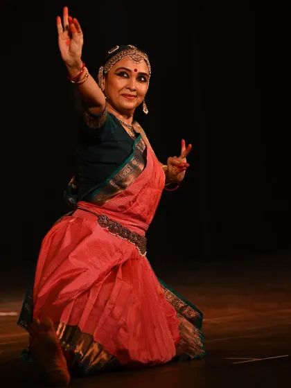 A graceful and expressive pose from a solo recital. The dancer's hands and face work together to convey a story to the audience.