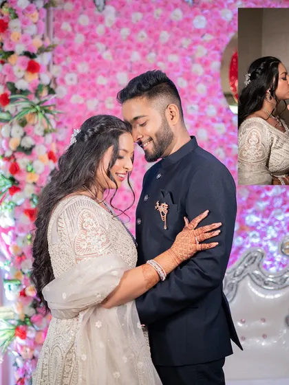 An intimate portrait from the engagement party, where the couple shares a close embrace against a backdrop of pink flowers.