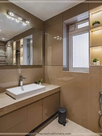We focus on sensible planning to meet everyday storage needs. This bathroom vanity provides ample drawer space and is paired with a mirrored cabinet and illuminated window-side shelving to maximize the use of space.
