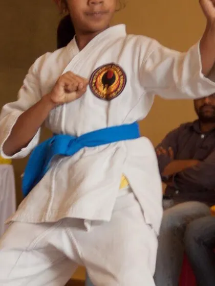 A young blue belt student demonstrates a strong fighting stance. We focus on building confidence and correct posture from the early stages.