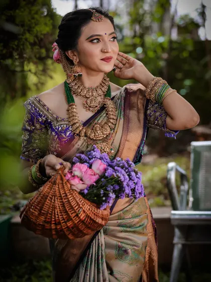 Another angle of our beautiful bride, showcasing the rich pallu of the Kanchipuram silk saree and the detailed embroidery on the blouse. We help you put together the entire look.