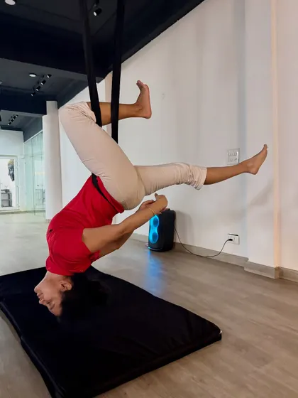 A moment of pure serenity in a supported inversion. This pose allows the spine to lengthen naturally, relieving pressure and creating a sense of calm.