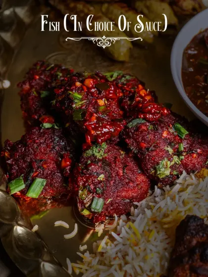 Our Dostana Thaal offers a choice of fish preparations, like this spicy fish starter tossed in a fiery red sauce, served over fragrant rice.