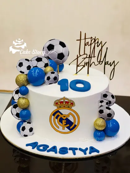 Kicking off a 10th birthday in style with this Real Madrid themed cake, decorated with a cascade of footballs and the team's logo.