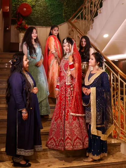 A beautiful portrait of the bride with her bridesmaids. The composition on the staircase creates a classic, elegant group photo.