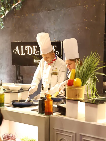 Our international team brings global expertise to your event. Here, our Italian chefs are at the Al Dente live pasta station, serving not just pasta, but poetry on a plate, freshly prepared to engage and delight your guests.