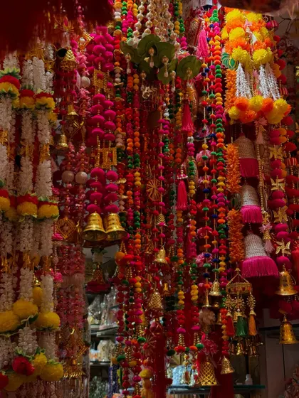 A shop filled with colorful garlands and decorations for Diwali. The sheer variety of colors and textures makes for a wonderfully rich and festive photograph.