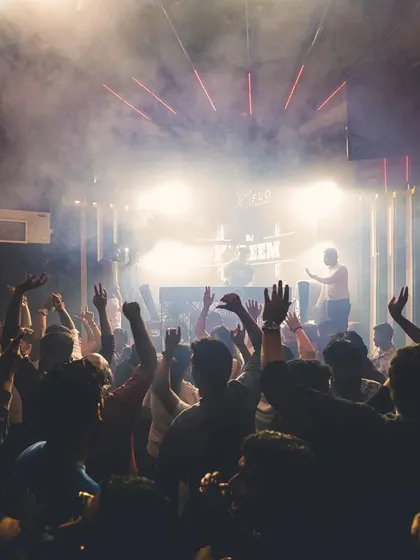 A sea of hands in the air at one of my club nights. My goal is simple: get everyone moving and vibing together on the dance floor.