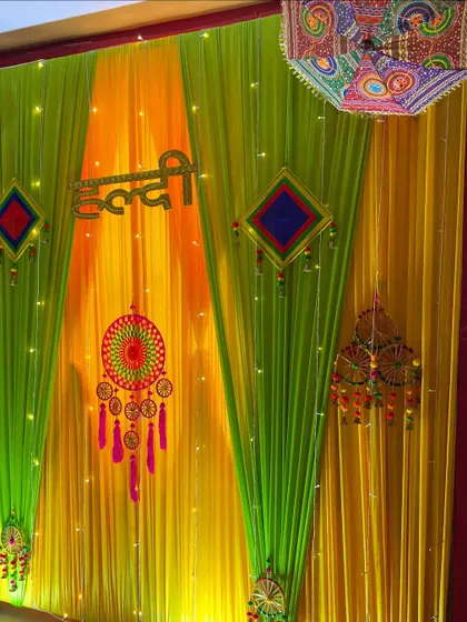 A close-up view of the Haldi backdrop, showing the texture of the drapes, the intricate dreamcatcher, and the sparkle of the integrated fairy lights.