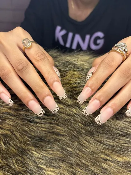 A full view of the animal print French tip design, a perfect example of how we can customize a classic look.