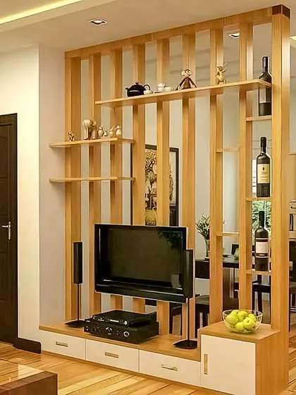 This wooden partition is a great example of how I divide spaces functionally without building a solid wall. It acts as both a TV unit and a display shelf, maintaining an open and connected feel between the living and dining areas.