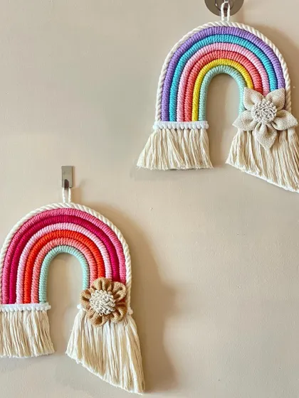 These large macrame rainbows are a customer favorite. They can be customized with or without the floral accent and come in a variety of color palettes to match any room decor.