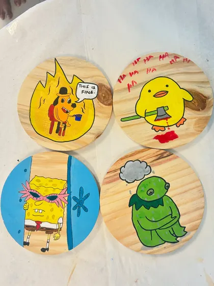 A set of four fun, meme-inspired paintings on wooden coasters. We love it when guests bring their unique ideas to the studio!