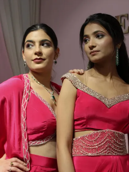 A close-up of two of our pink outfits from the 'DESIRE' collection, showing the delicate hand-embroidered borders.