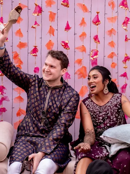A close-up of the couple's happy faces during the Mehendi games, showcasing the joy and connection these activities bring to the celebration.