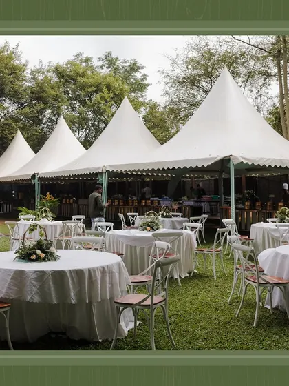 Outdoor seating for the brunch, featuring classic round tables and chairs under large pagodas. This setup provided a comfortable and elegant dining space for guests on the lawn.