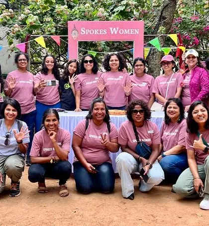 The SpokesWomen volunteer team waving for a photo. Their energy and dedication are what make our events so special.